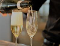Two champagne flutes being filled
