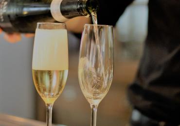 Two champagne flutes being filled