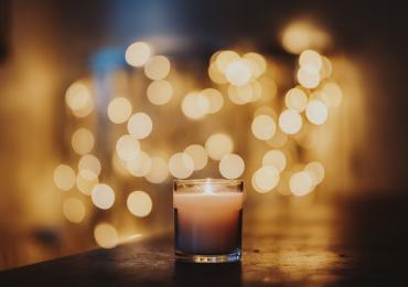 Candle with bokeh lights behind